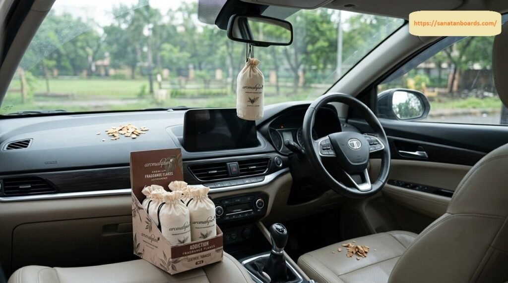An interior view of a car displaying Aromahpure Premium Fragrance Flakes air fresheners in fabric pouches, with one hanging from the rearview mirror and a product box on the center console.